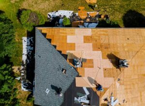 A close-up view of several different roofing materials side by side on a house roof under natural daylight.