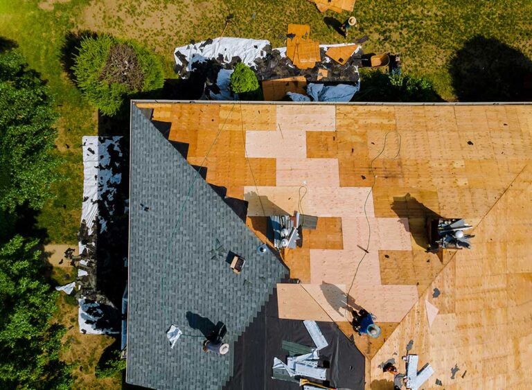A close-up view of several different roofing materials side by side on a house roof under natural daylight.